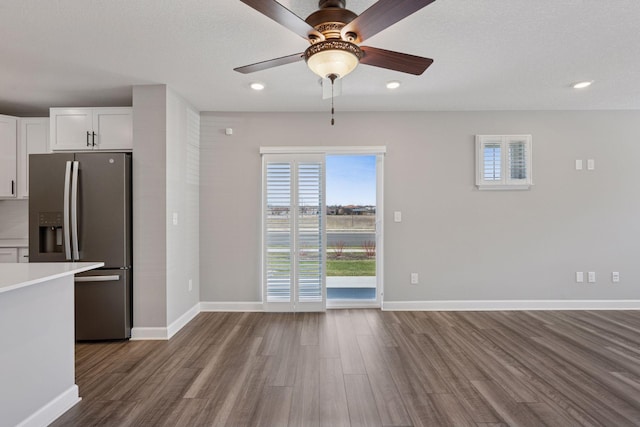 8730 Parkington Ave NE, Otsego, MN 55330 - kitchen with light countertops, white cabinetry, dark wood-style flooring, stainless steel fridge, and ceiling fan