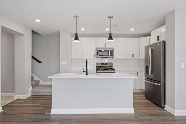 8730 Parkington Ave NE, Otsego, MN 55330 - kitchen featuring light countertops, stainless steel appliances, dark wood-style floors, and a sink