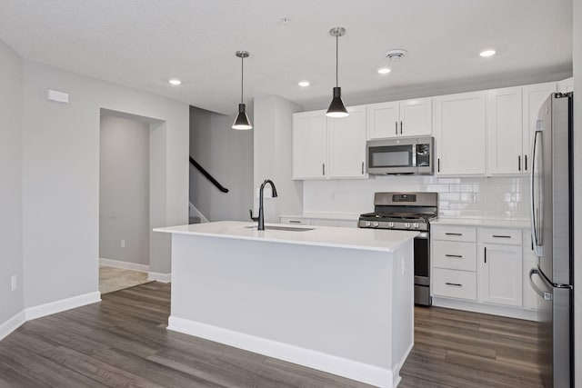 8730 Parkington Ave NE, Otsego, MN 55330 - kitchen with tasteful backsplash, a sink, stainless steel appliances, a center island with sink, and white cabinetry