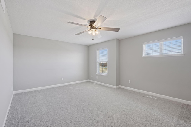 8730 Parkington Ave NE, Otsego, MN 55330 - unfurnished room with baseboards, light carpet, a ceiling fan, and plenty of natural light