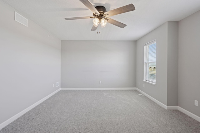 8730 Parkington Ave NE, Otsego, MN 55330 - spare room with ceiling fan, carpet floors, visible vents, and baseboards