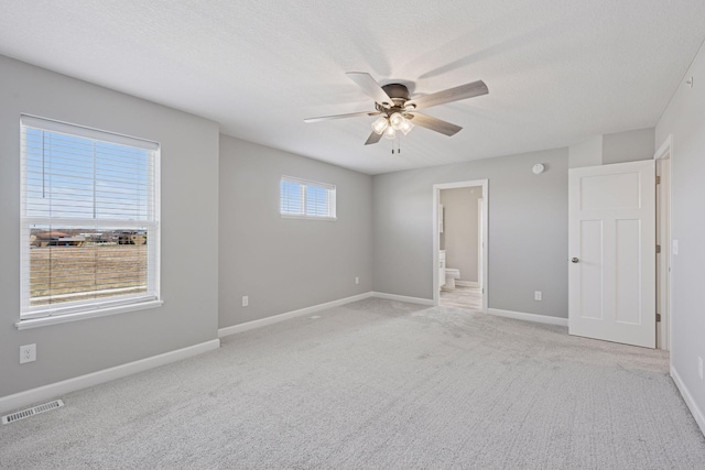 8730 Parkington Ave NE, Otsego, MN 55330 - unfurnished room with baseboards, visible vents, ceiling fan, and light colored carpet