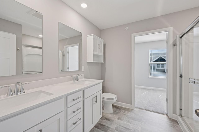 8730 Parkington Ave NE, Otsego, MN 55330 - full bath with baseboards, toilet, a stall shower, and a sink
