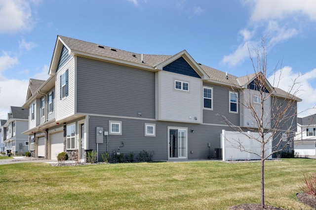8730 Parkington Ave NE, Otsego, MN 55330 - back of property featuring central AC, a yard, and a garage