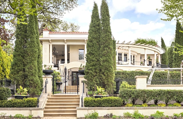 2427 Lake Of The Isles Pkwy, Minneapolis, MN 55405 - greek revival inspired property with stucco siding, a pergola, a chimney, and a gate