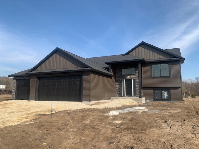 view of front facade with board and batten siding and driveway