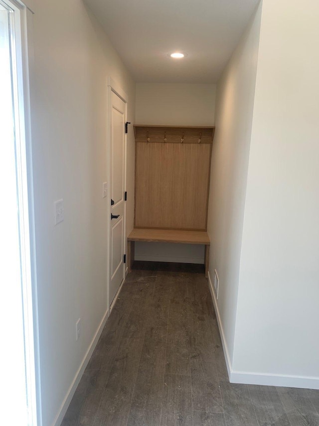 hallway featuring recessed lighting, visible vents, baseboards, and wood finished floors