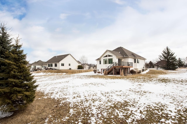 snow covered house with stairway