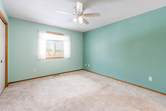 unfurnished bedroom with a closet, a textured ceiling, visible vents, and carpet flooring