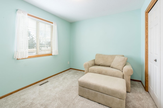 sitting room featuring visible vents, carpet flooring, and baseboards