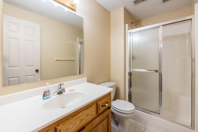 full bathroom with vanity, tile patterned floors, toilet, and a stall shower