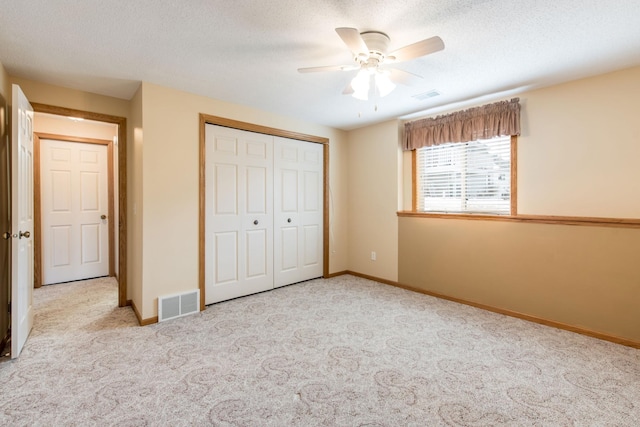 unfurnished bedroom featuring a closet, visible vents, and carpet floors