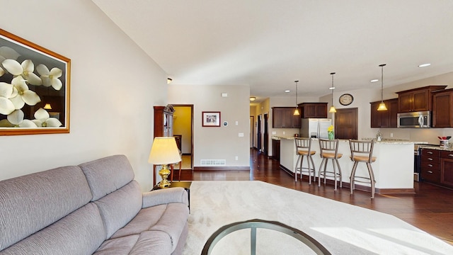 living room with recessed lighting, visible vents, baseboards, and dark wood-style floors