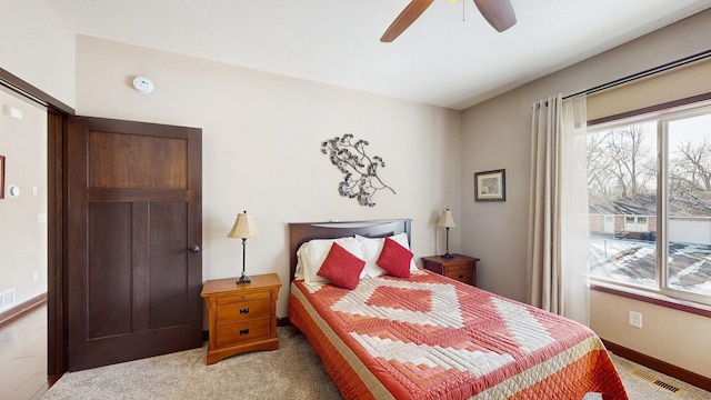 bedroom featuring visible vents, a ceiling fan, carpet, and baseboards