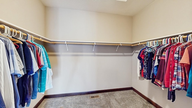 walk in closet with visible vents and carpet floors