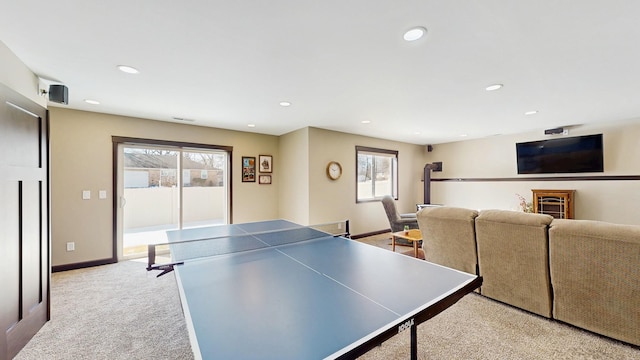 recreation room featuring recessed lighting, plenty of natural light, light colored carpet, and baseboards