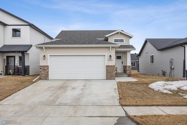 view of front of home with brick siding, concrete driveway, an attached garage, and a shingled roof