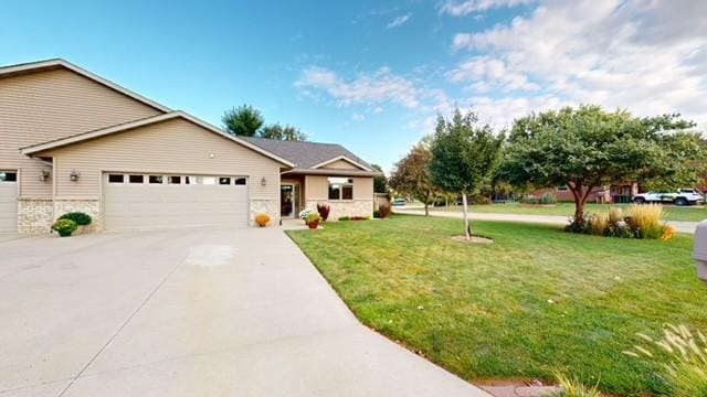 single story home with driveway, an attached garage, and a front lawn