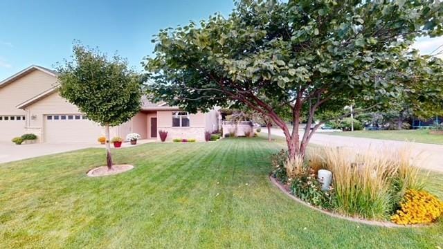 view of front of home with a front yard, an attached garage, and driveway