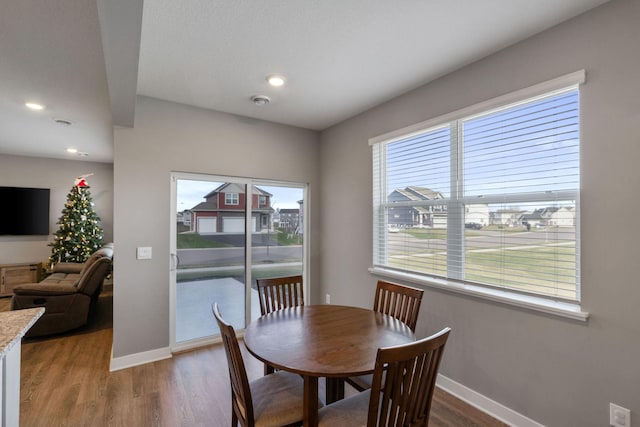 dining area featuring recessed lighting, wood finished floors, and baseboards