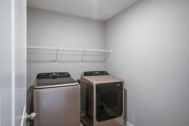 laundry area with laundry area and independent washer and dryer