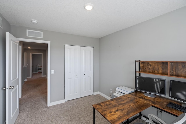 office area featuring baseboards, visible vents, a textured ceiling, and carpet flooring