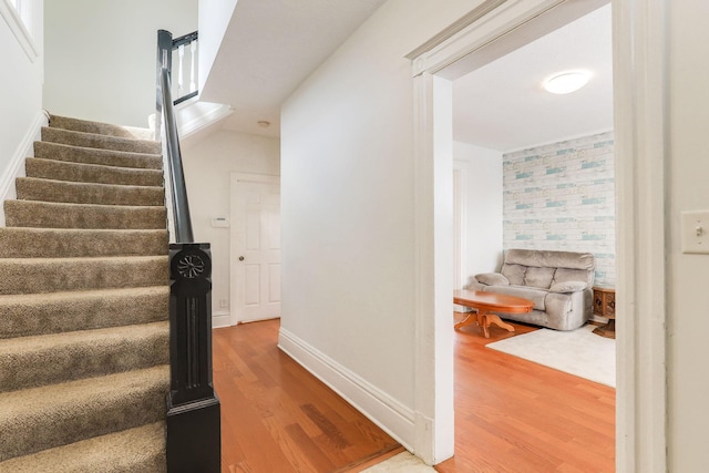 stairs with baseboards and wood finished floors