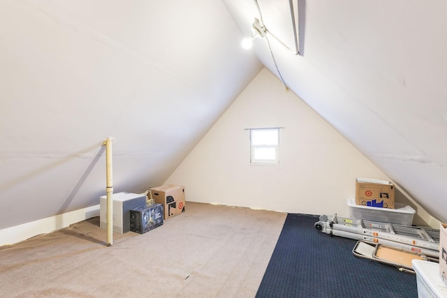 additional living space with carpet flooring and lofted ceiling