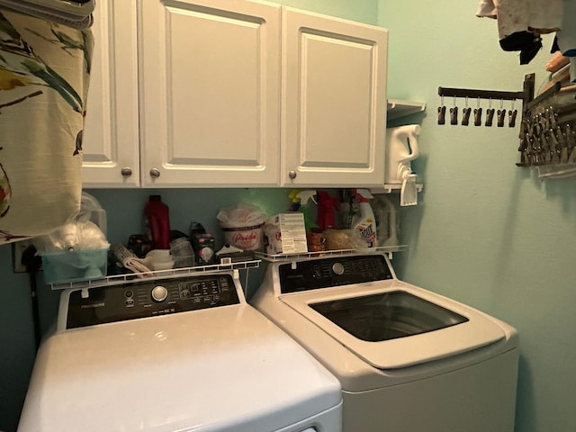 laundry area with cabinet space and washer and clothes dryer