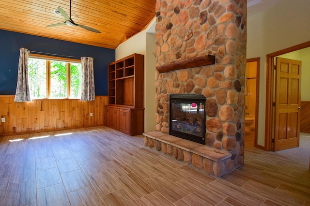 15633 Explorer Ln, Park Rapids, MN 56470 - unfurnished living room with wainscoting, a fireplace, ceiling fan, vaulted ceiling, and wooden ceiling