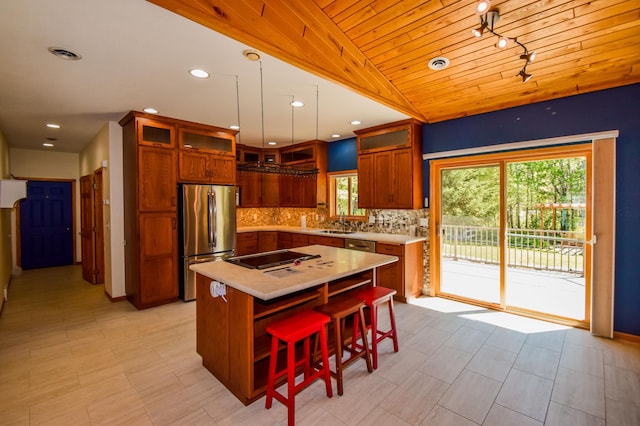 15633 Explorer Ln, Park Rapids, MN 56470 - kitchen featuring freestanding refrigerator, light countertops, decorative backsplash, black electric stovetop, and a kitchen bar