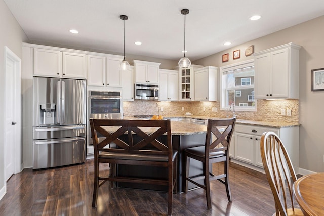 kitchen featuring dark wood-type flooring, appliances with stainless steel finishes, and white cabinets