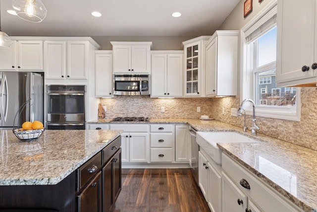 kitchen with recessed lighting, white cabinetry, dark wood finished floors, and stainless steel appliances