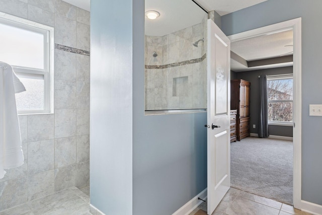 full bath with tile patterned flooring, a walk in shower, and baseboards