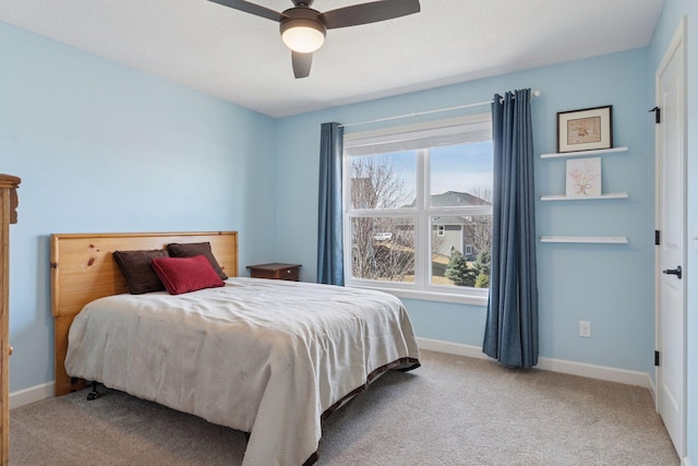 carpeted bedroom with baseboards and a ceiling fan