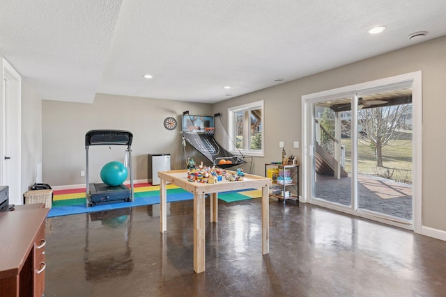 game room with concrete flooring, baseboards, recessed lighting, and a textured ceiling