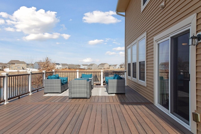 wooden terrace featuring an outdoor hangout area and a residential view