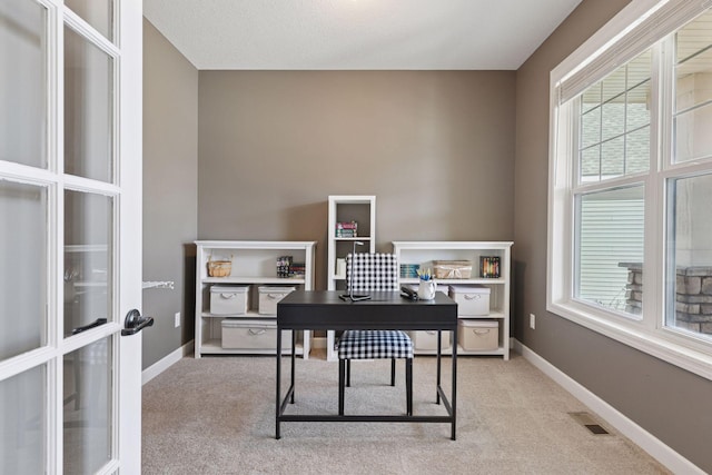 home office with carpet flooring, baseboards, and visible vents