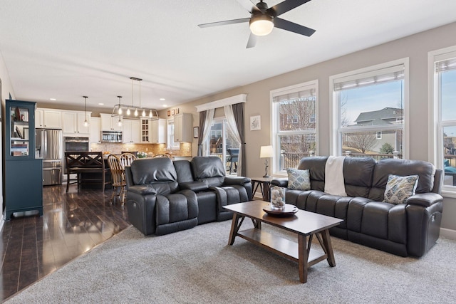 living area with a ceiling fan, recessed lighting, a healthy amount of sunlight, and dark wood-type flooring