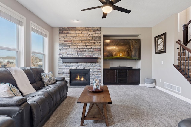 4520 Bailey Lake Dr, Woodbury, MN 55129 - living room with stairway, ceiling fan, carpet, baseboards, and a fireplace