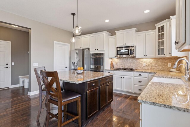 4520 Bailey Lake Dr, Woodbury, MN 55129 - kitchen with appliances with stainless steel finishes, dark wood finished floors, white cabinets, and recessed lighting