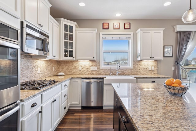 4520 Bailey Lake Dr, Woodbury, MN 55129 - kitchen featuring appliances with stainless steel finishes, a sink, white cabinets, recessed lighting, and glass insert cabinets