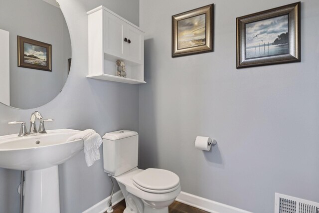 4520 Bailey Lake Dr, Woodbury, MN 55129 - bathroom featuring toilet, wood finished floors, baseboards, and a sink