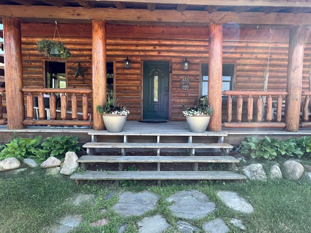 view of exterior entry with a porch