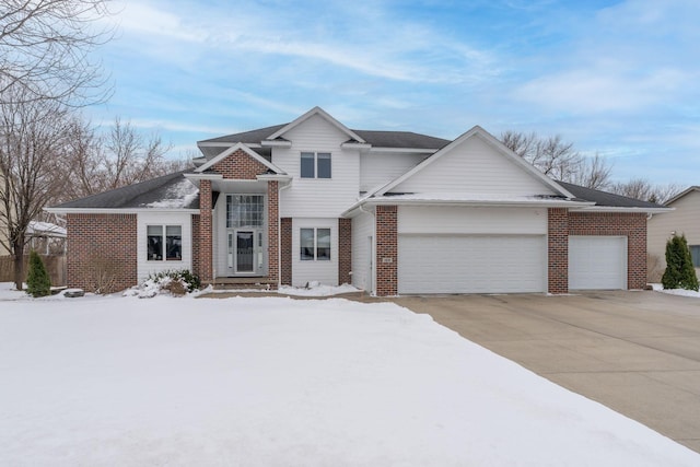 view of front facade with brick siding, an attached garage, and driveway