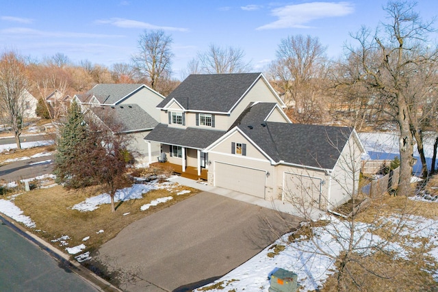 view of front of house featuring aphalt driveway, roof with shingles, and fence