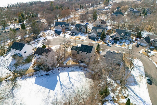 snowy aerial view with a residential view