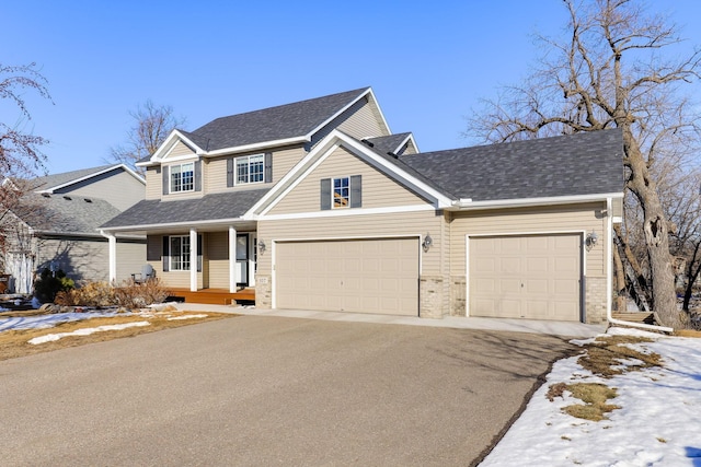 view of front of property with aphalt driveway, covered porch, and a shingled roof