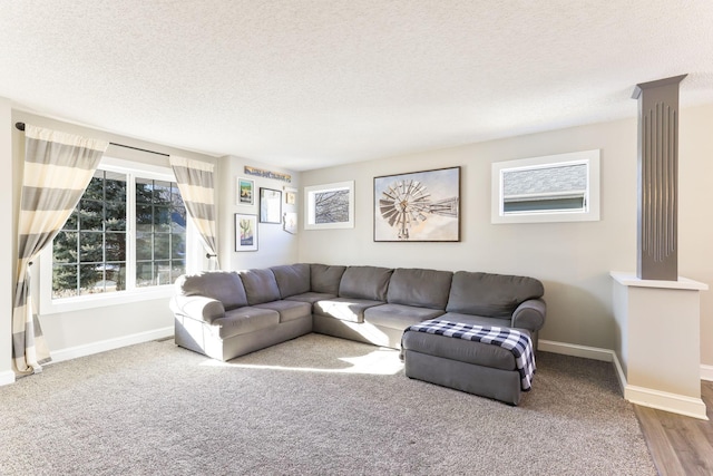 living area with a textured ceiling and baseboards