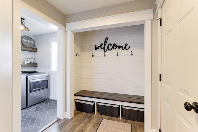 mudroom featuring wood finished floors and washing machine and dryer